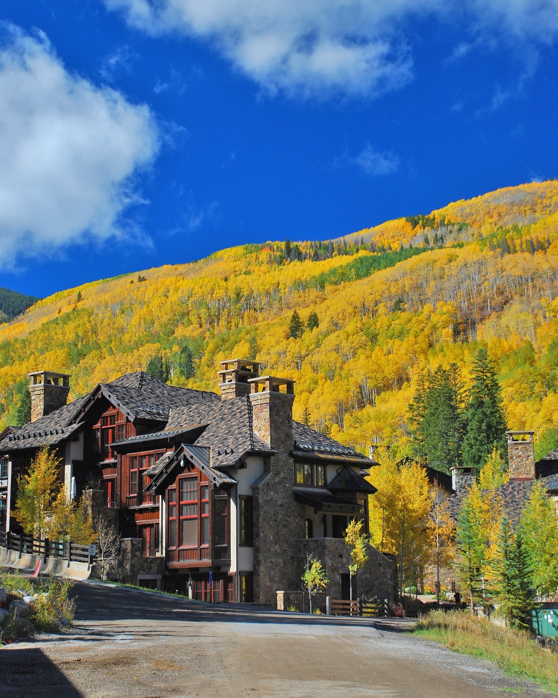 Mountain home among autumn aspens